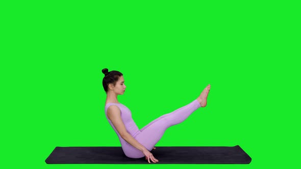 Beautiful Athletic Woman Doing Yoga Boat Pose on Mat Against Green Screen