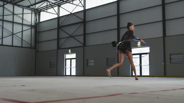 Female gymnast performing at sports hall alt