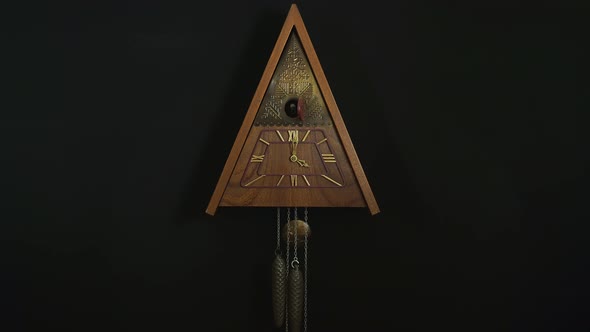 Mechanical Clock With A Cuckoo On A Black Background.