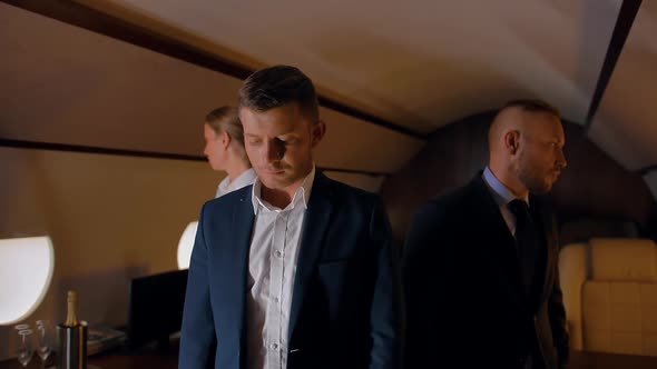 Three Confident Business People Inside of Luxury Business Jet alt