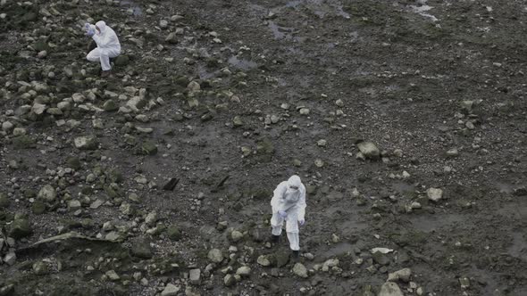 Forensic scientist examining sample at river bank