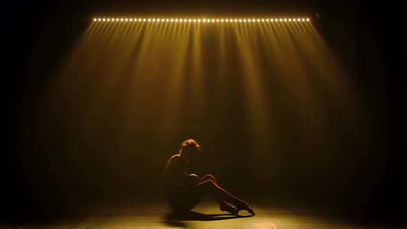 A Young Gymnast Performs Exercises with a Ball, Rolls It Hand and Body and Does Somersaults alt