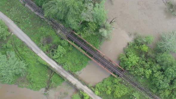Road and railway bridge above the river from drone perspective 4K drone video alt