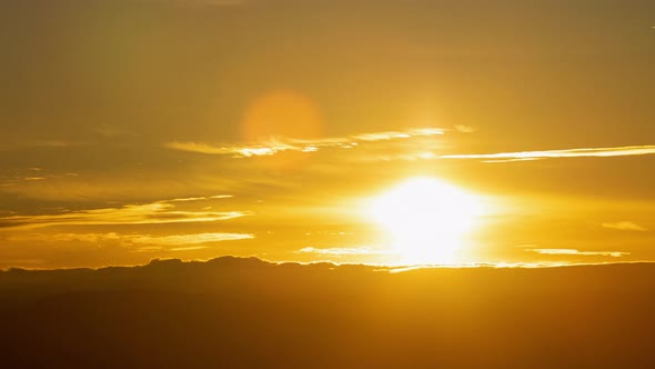 Golden Sunrise Behind Thin Layer of Clouds Close Up Timelapse