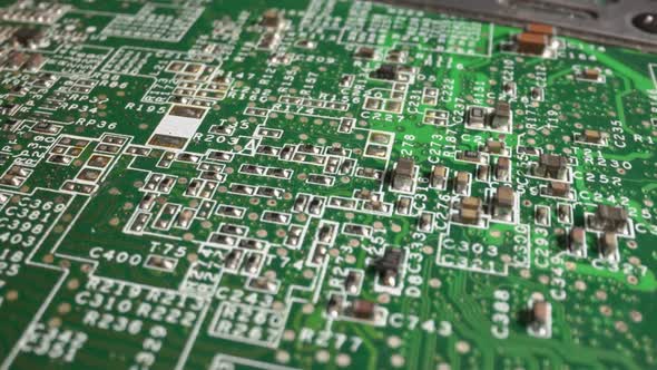 Extreme close-up of green Printed Circuit Board Electronics shot with dolly alt