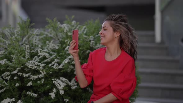 Woman is Communicating Emotionally By Video Call in Smartphone Holding Modern Gadget alt