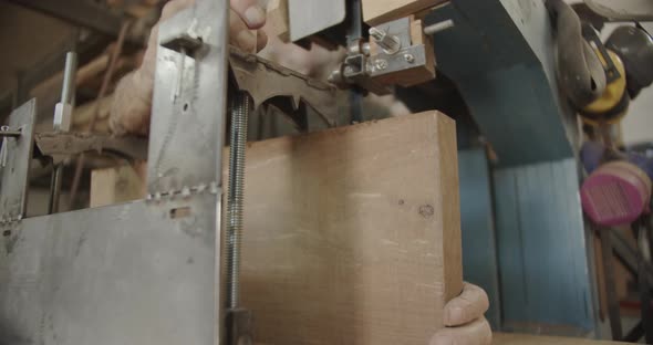 Woodworker tightens screw on a metal plate