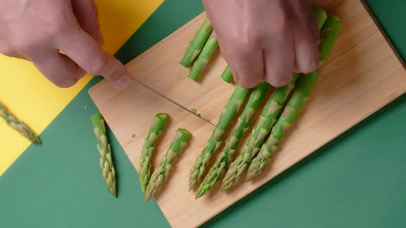 Vertical Flat Lay Video the Cook Puts Plate of Cooked Potato Dumplings with Baked Asparagus