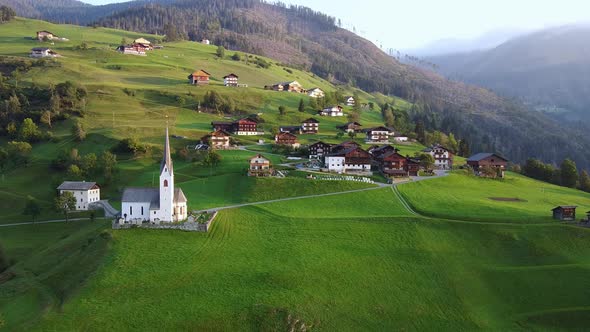 Aerial View of Villas and Church on Austrian Mountains alt