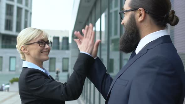 Smart Blonde Woman Giving Male Colleague High-Five Gesture, Business Winners