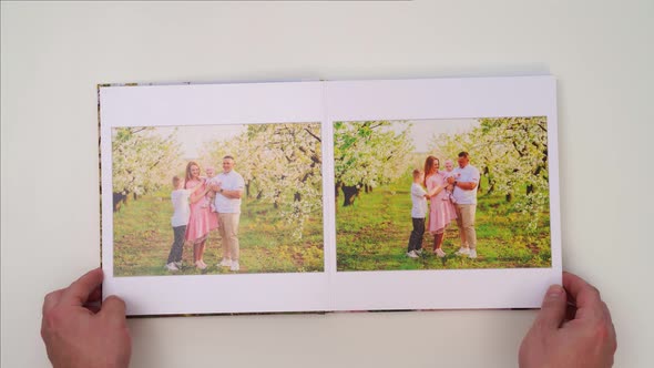 White Background Leaf Through Photobook From Family Photo Shoot in Spring Garden alt