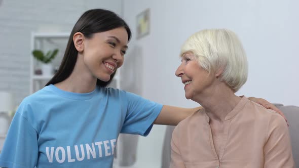 Female Activist Hugging Mature Woman Smiling Each Other, Social Volunteering alt