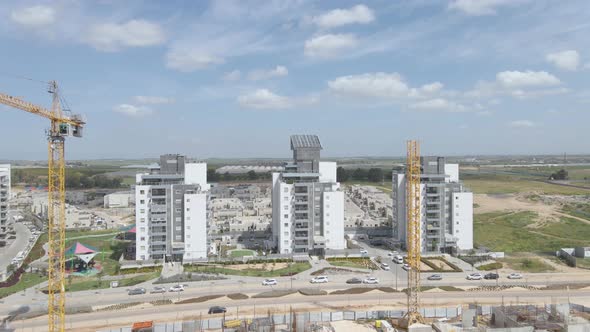 new neighborhood's buildings with cranes at southern district city netivot alt