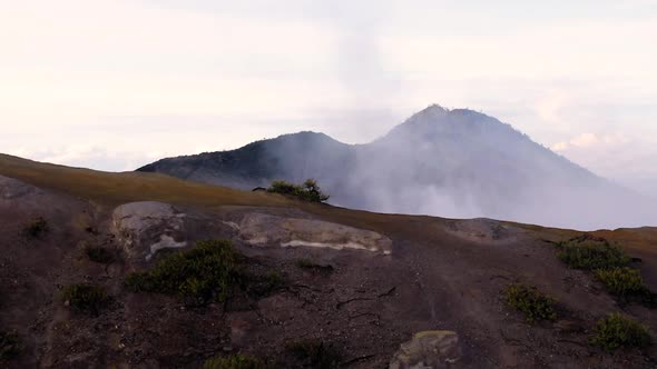 Crater of Ijen volcano, Java, Indonesia. Landscape with the green lake and the smoke alt