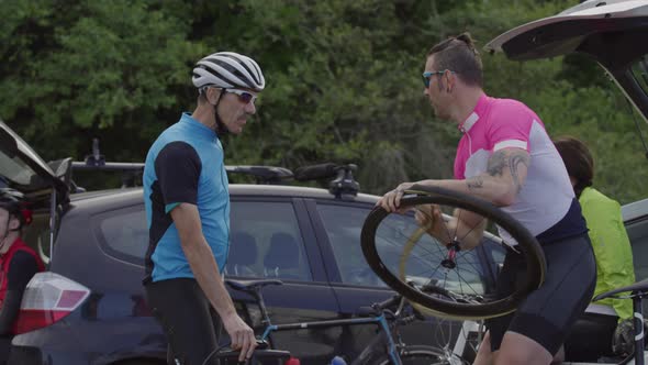 Cyclists fixing tire and preparing bicycle for ride.  Fully released for commercial use.