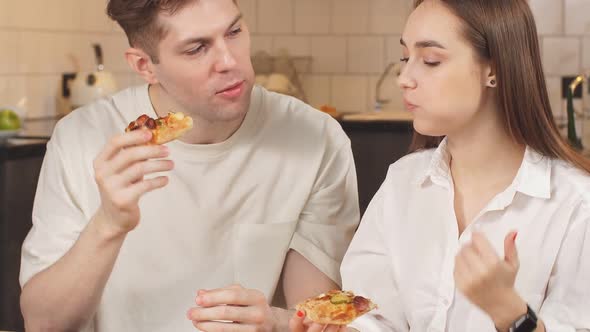 Happy Caucasian Couple Eat Pizza at Home