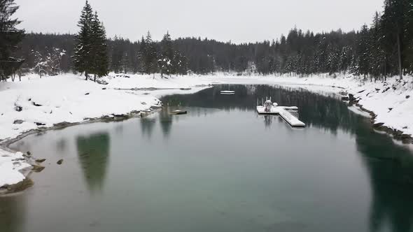 Aerial flying through Caumalake during winter season, Flims - Switzerland alt