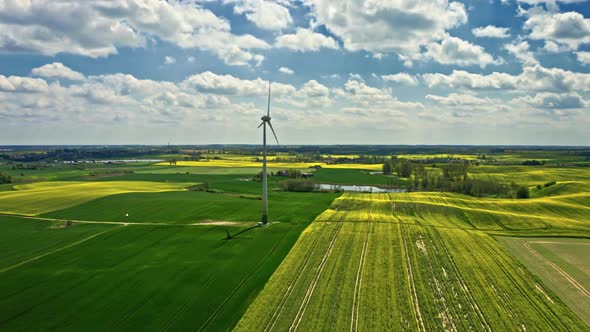 Stunning yellow rape fields and wind turbine. Poland agriculture. alt
