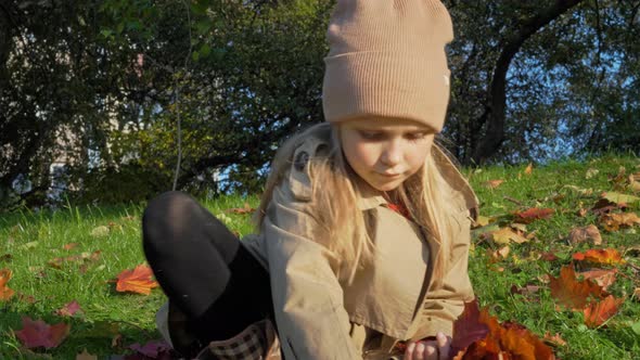 Little Girl in Autumn Park