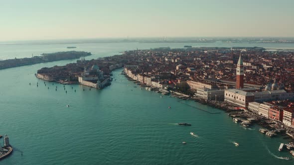 Descending drone shot over Venice Lagoon of St Marco Square and Basilica di Santa Maria alt