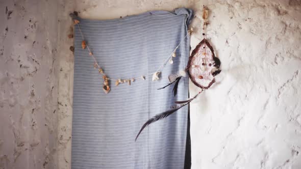 Dreamcatcher and seashell garland hanging on wall