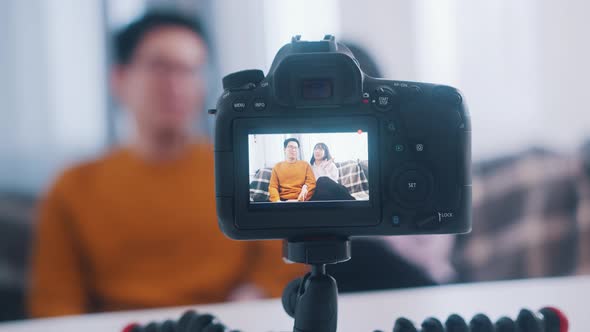 Young Asian Couple Influencers Streaming From the Comfort of Their Home alt