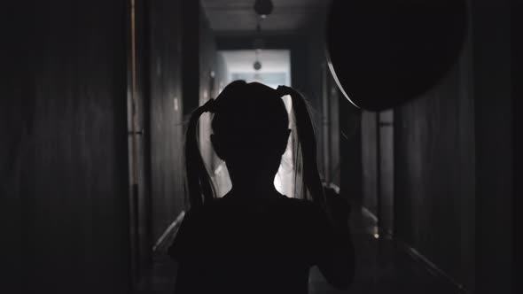 Little Girl with Balloon Walking along Hallway