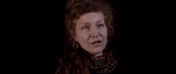 Curly redhead woman panting in tears and mouth open