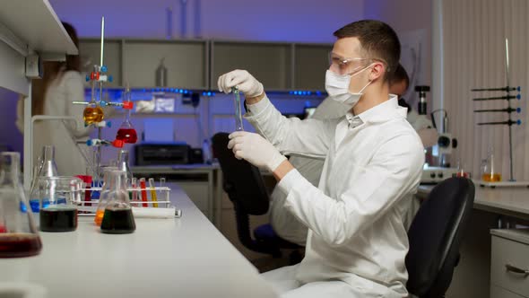 Young Scientist Mixing Colored Liquids