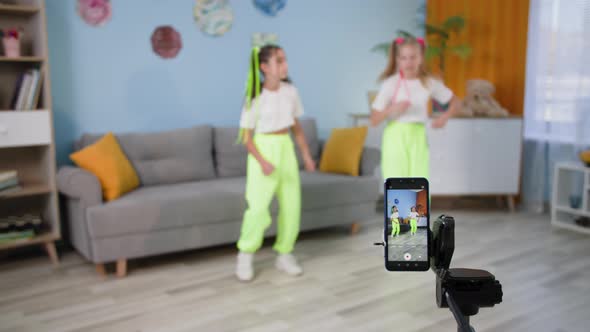 Children at Home Make Content Girlfriends Dancing Together in Front of Cell Phone Camera Then Show alt