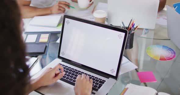 Close up of biracial woman working using laptop with copy space alt