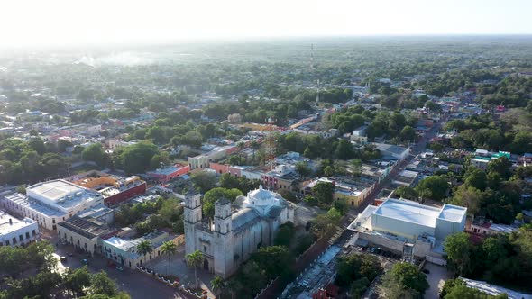 High aerial orbit to left, early in morning, around the Cathedral de San Gervasio in Valladolid, Yuc alt