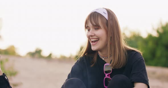 Close Up View of Beautiful Young Girl Smiling to Their Friends While Having a Picnic at the alt