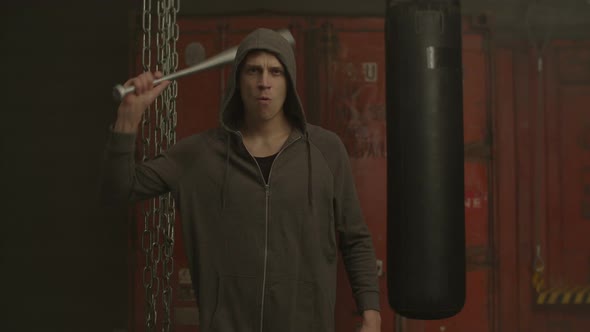 Hooligan in Hoodie Threatening with Baseball Bat alt