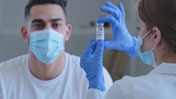 Unrecognizable Doctor Woman Nurse in Medical Mask and Latex Gloves Holds Shows Bottle with Covid19 alt