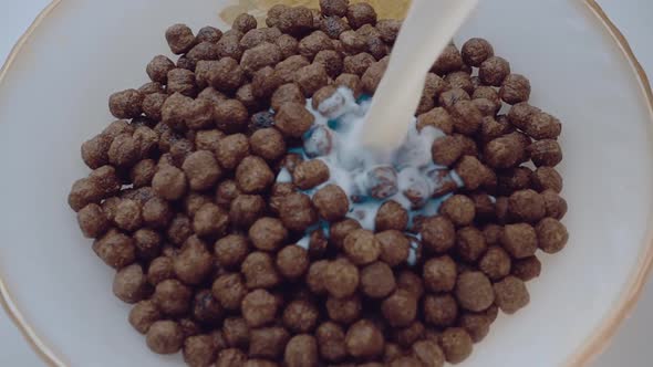 Brown Chocolate Corn Flakes Are Filled With Milk In A White Plate