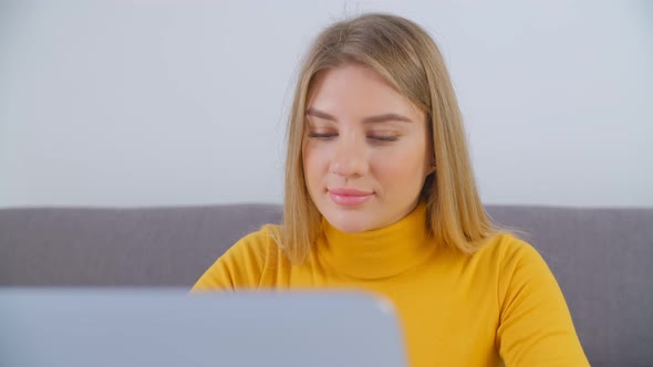 Blonde woman working freelance from home on lockdown in 4k video alt