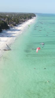 Vertical Video Kitesurfing Near the Shore of Zanzibar Tanzania alt