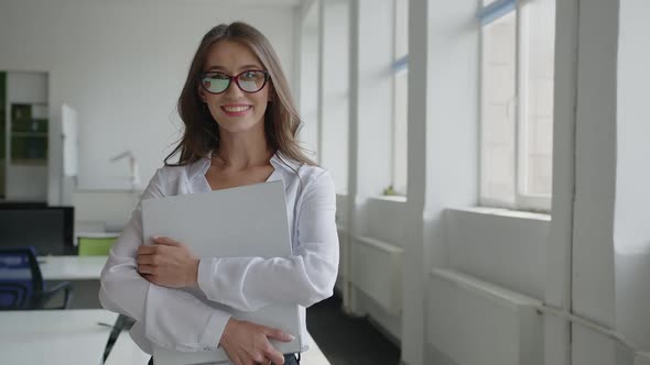Close Up View of Lady in Office in Red Glasses alt