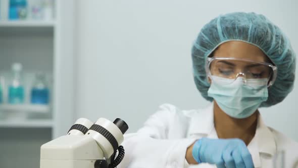 Biochemist Checking Liquids in Tubes on Transparency, Analyzing Biomaterial alt