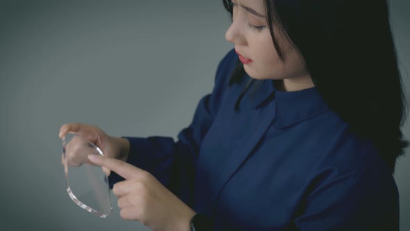 A futuristic mobile communication concept of a beautiful Asian woman using an advance transparent mo alt