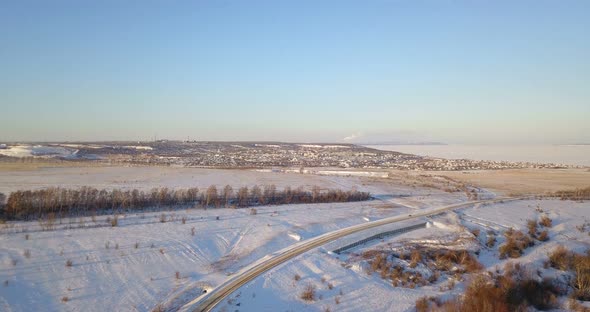 Car On Winter Road Near Town