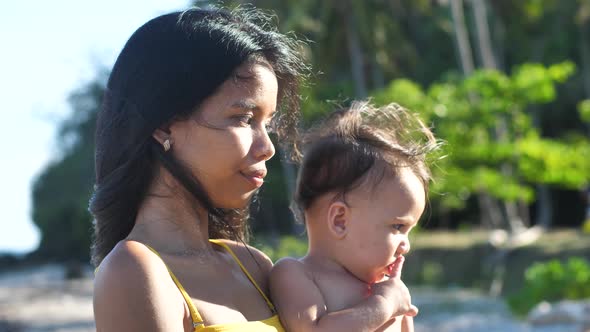 Portrait of Beautiful Young Asian Mother and Her Little Baby at the Beach