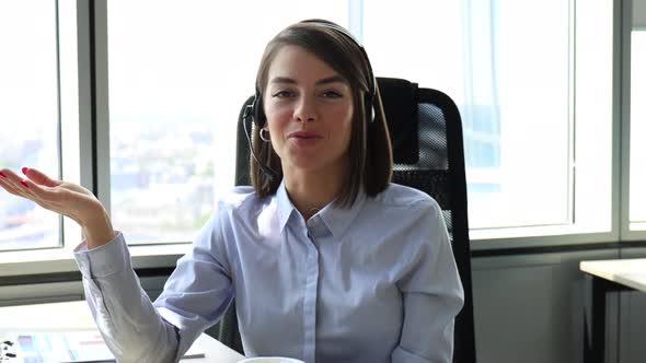 Young call operator businesswoman wears headset customer service manager looking alt
