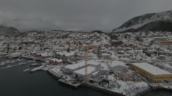 Snowy Houses At Skjervoy Village During Winter In Troms og Finnmark County, Norway. - aerial alt