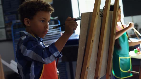 Attentive schoolboy panting on canvas alt