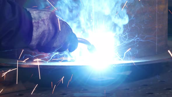 Bright Sparks From Welding Equipment While The Welder Is Working