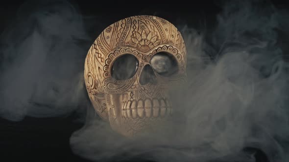 Skull Covered In Smoke On A Dark Background.