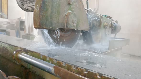 Large Industrial Stone Cutter Cuts Granite Rock Into Plates in Jets of Water Close Up