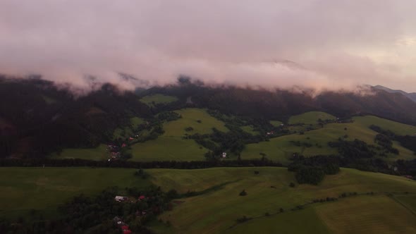 Aerial View  A Hilly Rural Landscape After a Burka Shrouded in Clouds at Dusk in the Golden Hour